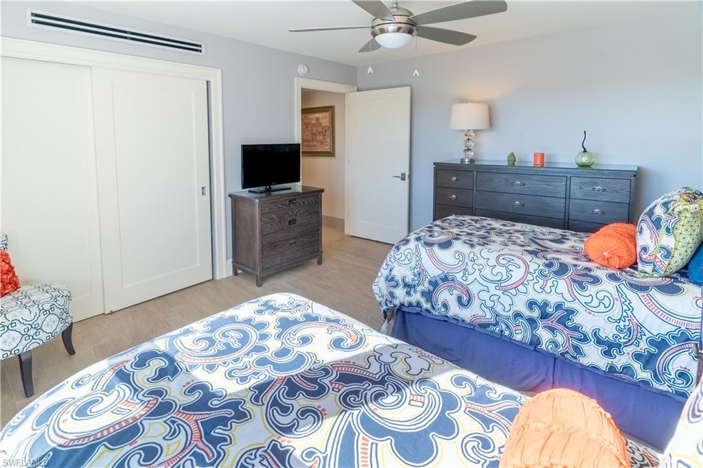 3 Bluebill Avenue, Unit 801 Naples, FL 34108 - Photo 13 of 29 a bedroom with a bed and furniture