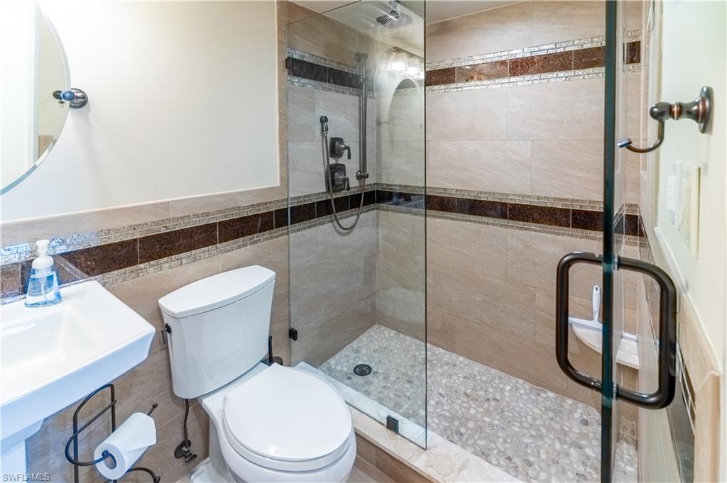 3 Bluebill Avenue, Unit 801 Naples, FL 34108 - Photo 19 of 29 a bathroom with a toilet and a shower