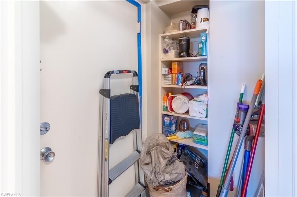 3 Bluebill Avenue, Unit 801 Naples, FL 34108 - Photo 5 of 29 a view of walk in closet with clothes and shoes