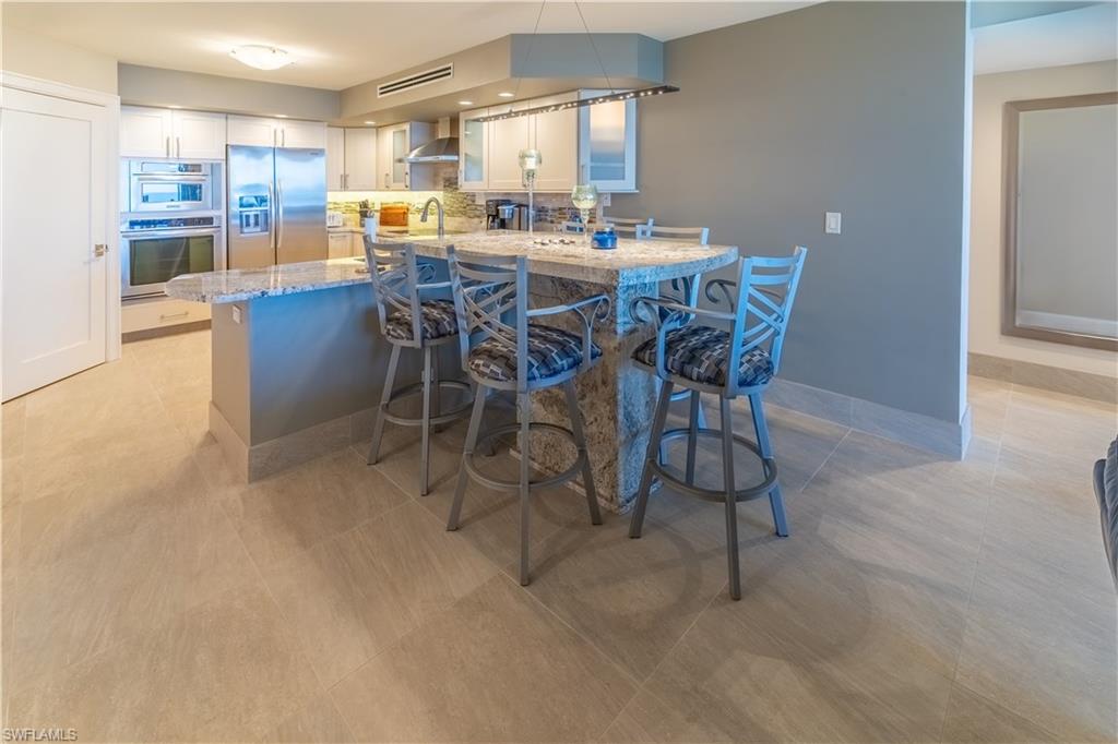 3 Bluebill Avenue, Unit 801 Naples, FL 34108 - Photo 8 of 29 a view of a dining room with furniture and a kitchen