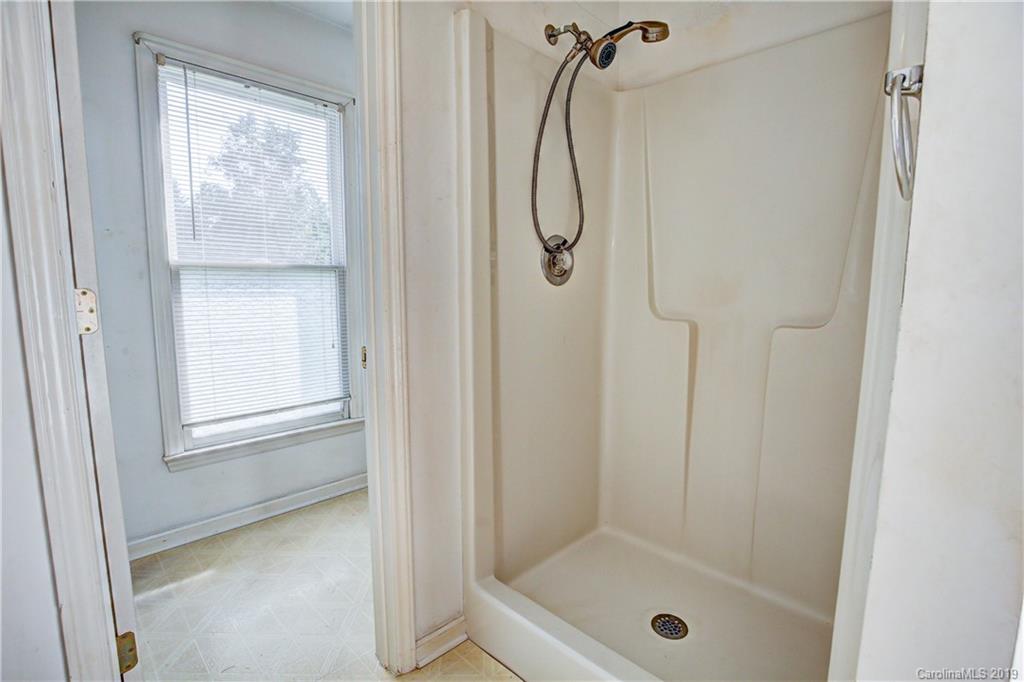 4123 White Store Road Wingate, NC 28174 - Photo 14 of 22 a bathroom with a glass shower door