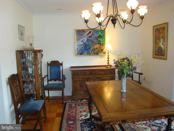 1 Hamill Road, Unit 1D Baltimore, MD 21210 - Photo 12 of 19 a living room with dining table and wooden floor
