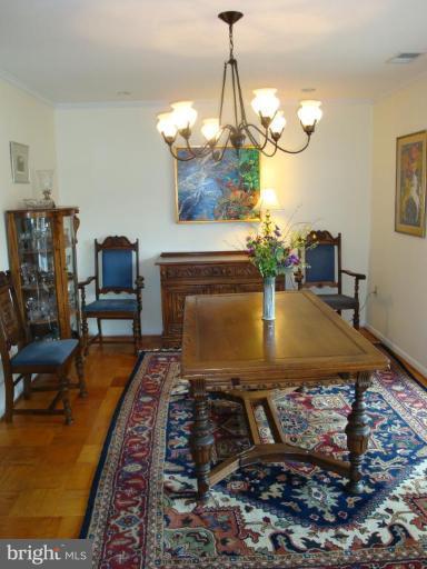 1 Hamill Road, Unit 1D Baltimore, MD 21210 - Photo 16 of 19 a living room with fireplace furniture and a chandelier