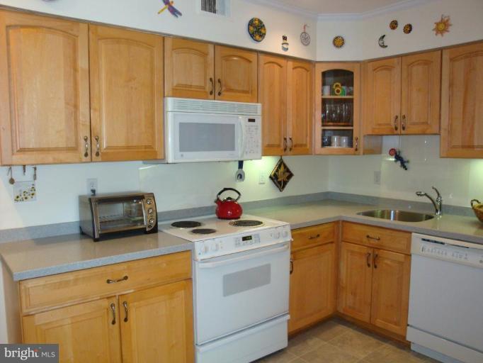 1 Hamill Road, Unit 1D Baltimore, MD 21210 - Photo 3 of 19 a kitchen with a sink dishwasher stove and cabinets