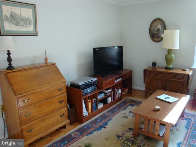 1 Hamill Road, Unit 1D Baltimore, MD 21210 - Photo 9 of 19 a room with furniture and flat screen tv
