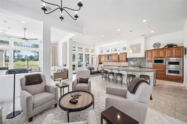 a living room with furniture flat screen tv and large window
