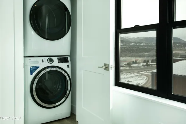 a view of a hallway with washer and dryer