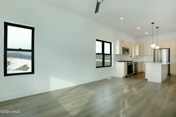 an empty room with windows and entrance