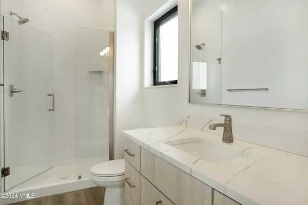 a bathroom with a sink toilet and shower