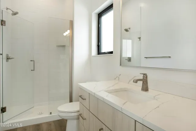 a bathroom with a sink toilet and shower