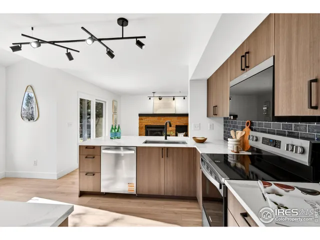 a kitchen with kitchen island a stove a sink and a microwave