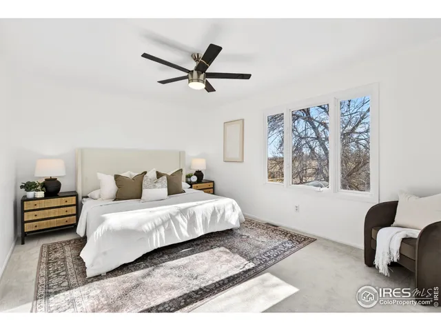 a bedroom with a bed and a ceiling fan