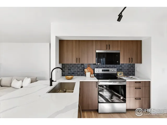 a kitchen with a stove a sink and a microwave