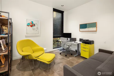 a view of a patio with couches and table and chairs under an umbrella