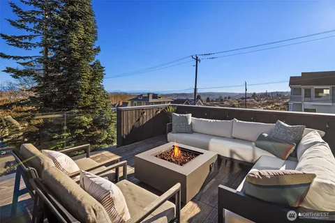 a view of a hallway with wooden floor and windows