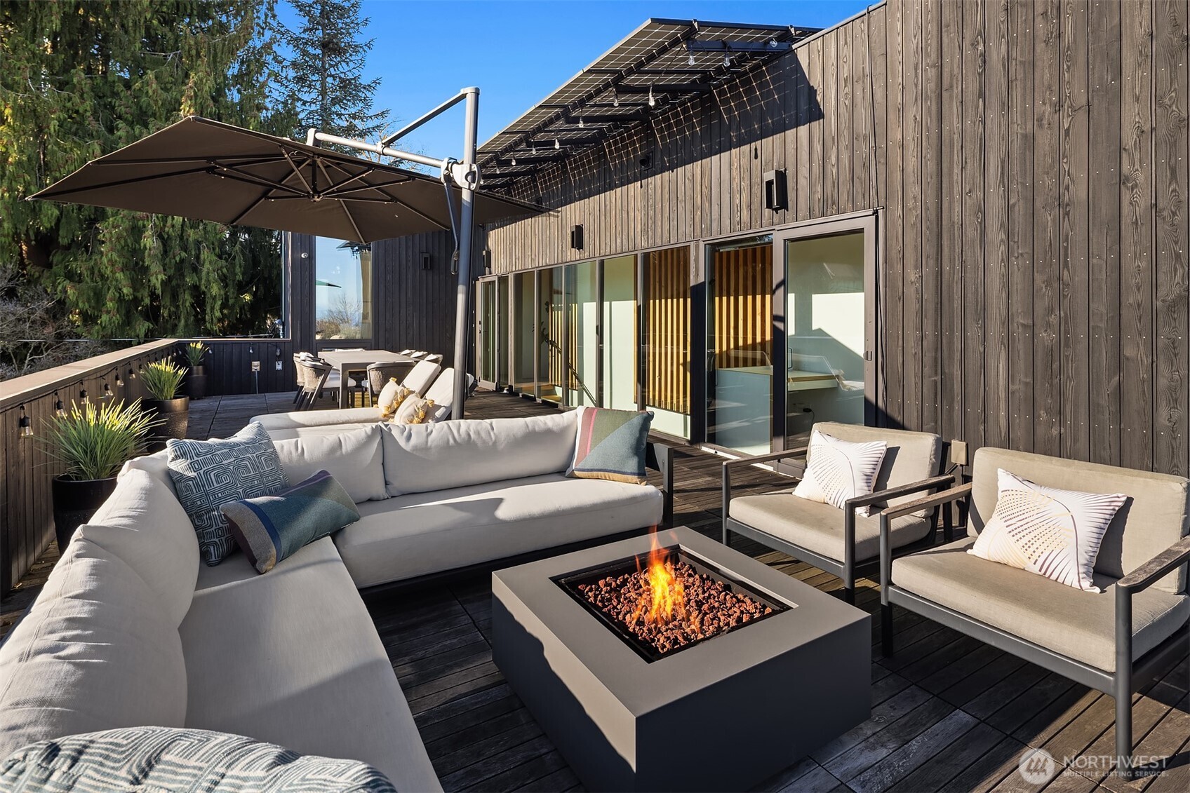 3057 36th Avenue Southwest Seattle, WA 98126 - Photo 20 of 40 a view of a patio with couches and table and chairs under an umbrella