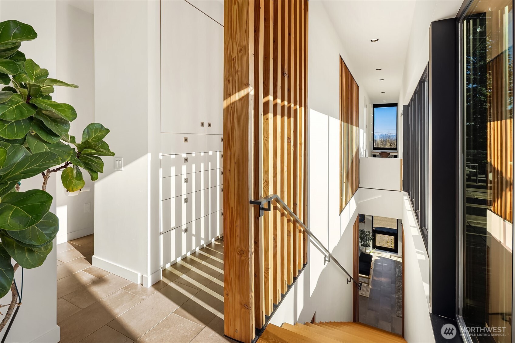 3057 36th Avenue Southwest Seattle, WA 98126 - Photo 23 of 40 a view of a hallway with wooden floor and windows