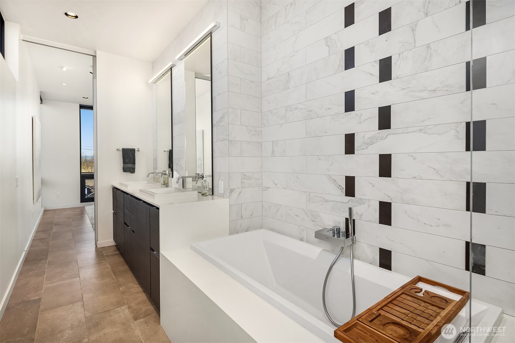 3057 36th Avenue Southwest Seattle, WA 98126 - Photo 27 of 40 a spacious bathroom with a double vanity sink a mirror and a bathtub