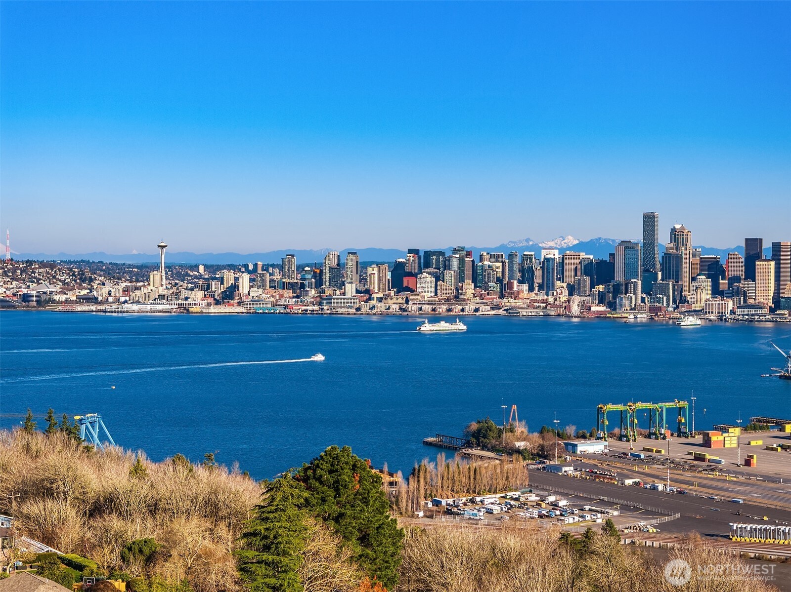 3057 36th Avenue Southwest Seattle, WA 98126 - Photo 40 of 40 a view of a lake with boats and trees in the background
