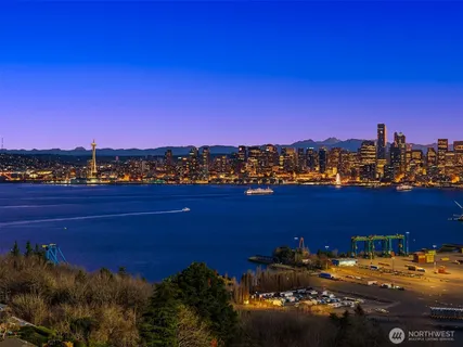 a living room with fireplace furniture and a large window