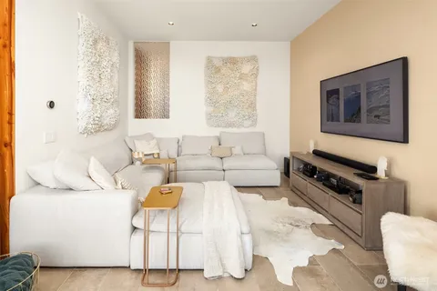 a living room with furniture a rug and a window