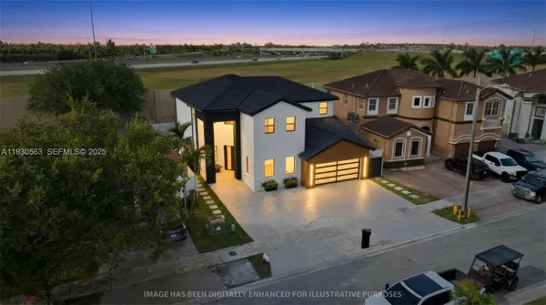 an aerial view of residential houses with outdoor space and lake view