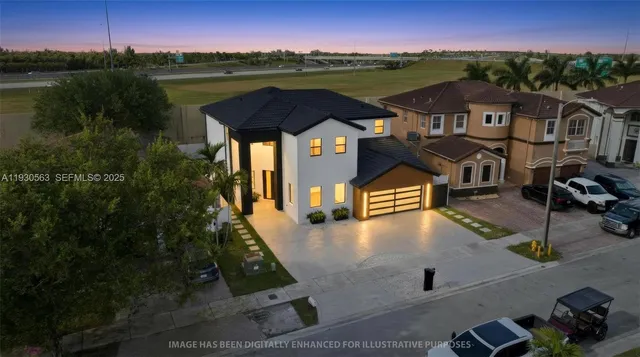 an aerial view of residential houses with outdoor space and lake view
