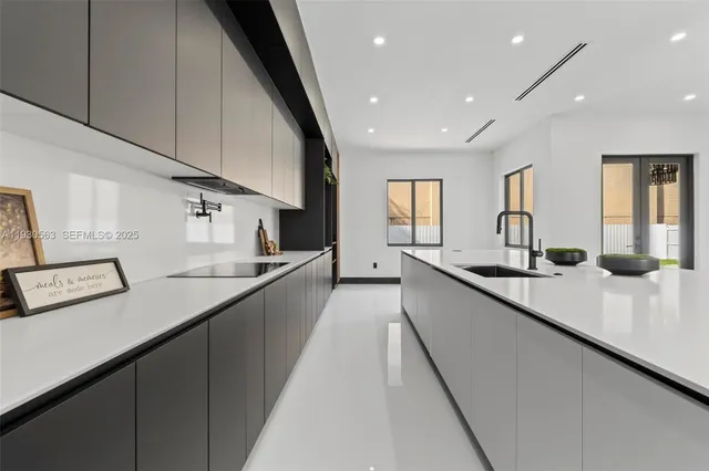 a kitchen with counter top oven and sink