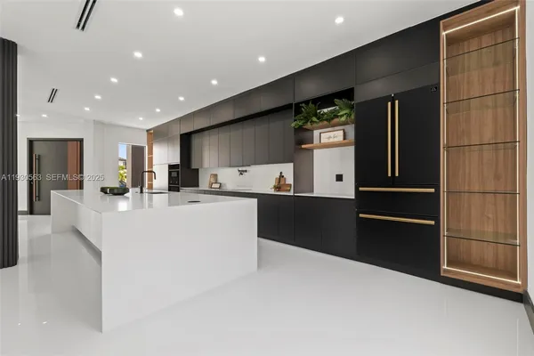 a kitchen with stainless steel appliances granite countertop a refrigerator and a stove