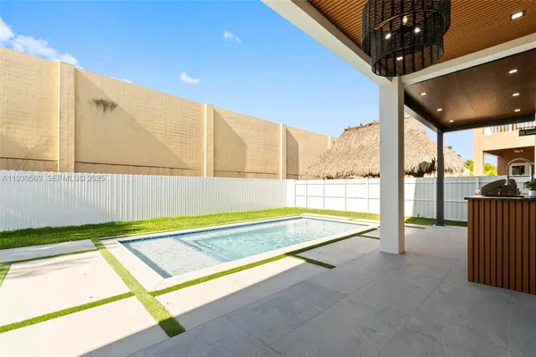a view of a house with swimming pool and a yard