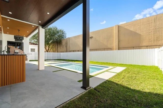 an empty room with windows and fireplace
