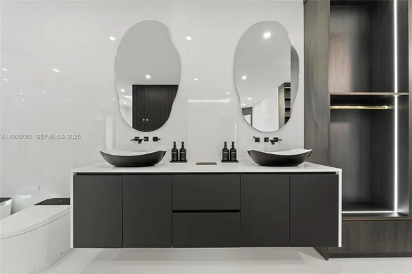 a view of a refrigerator in kitchen and an empty room