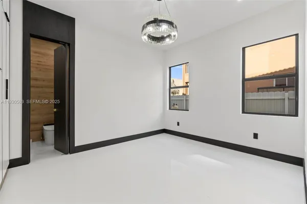 a view of an empty room with a bathroom