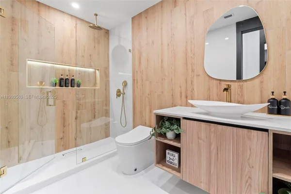a bathroom with a sink toilet and shower