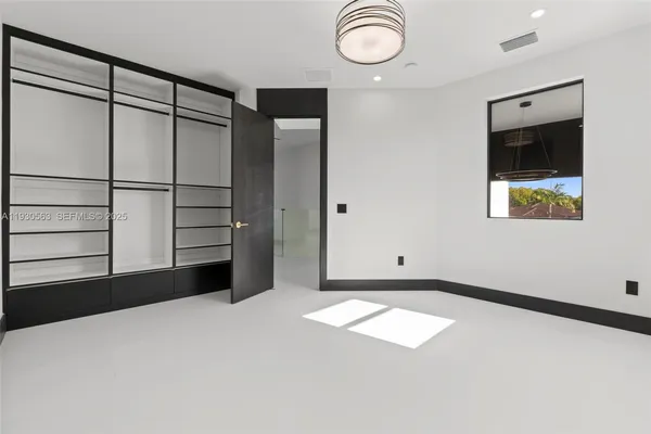 a view of a white house with a small yard and plants