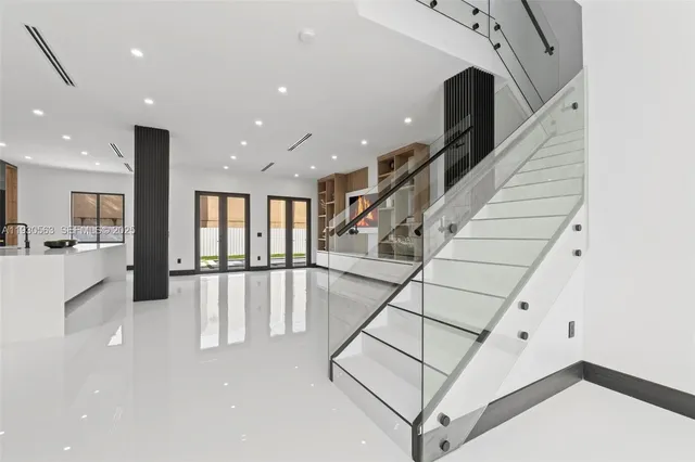 a view of staircase with white walls and windows