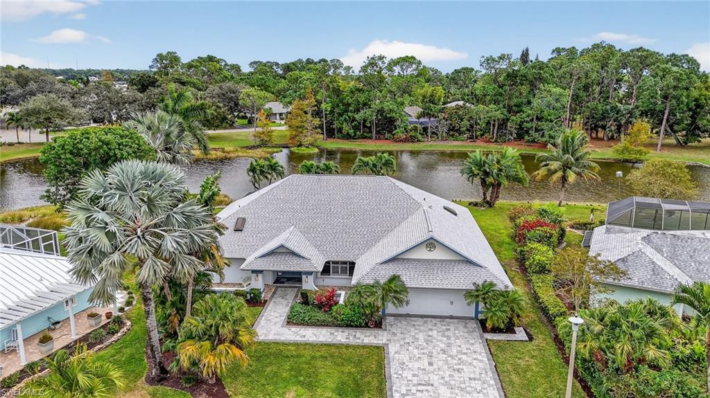 an aerial view of a house with garden space and a yard