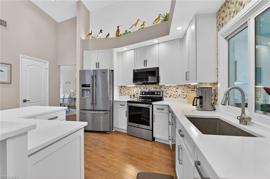2248 Prince Lane Naples, FL 34112 - Photo 13 of 47 a kitchen with a sink a stove and refrigerator