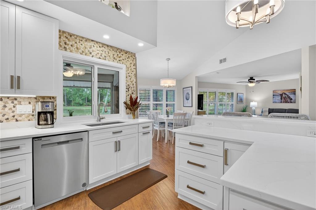 2248 Prince Lane Naples, FL 34112 - Photo 14 of 47 a kitchen with white cabinets and sink