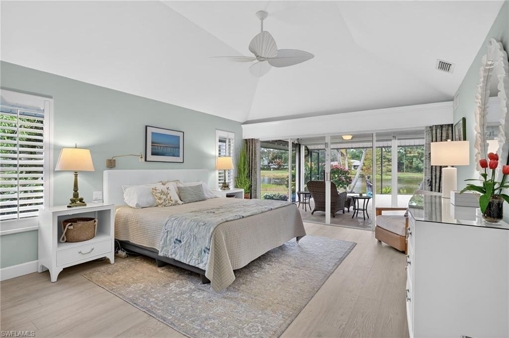 2248 Prince Lane Naples, FL 34112 - Photo 21 of 47 a bedroom with a large bed and a chandelier