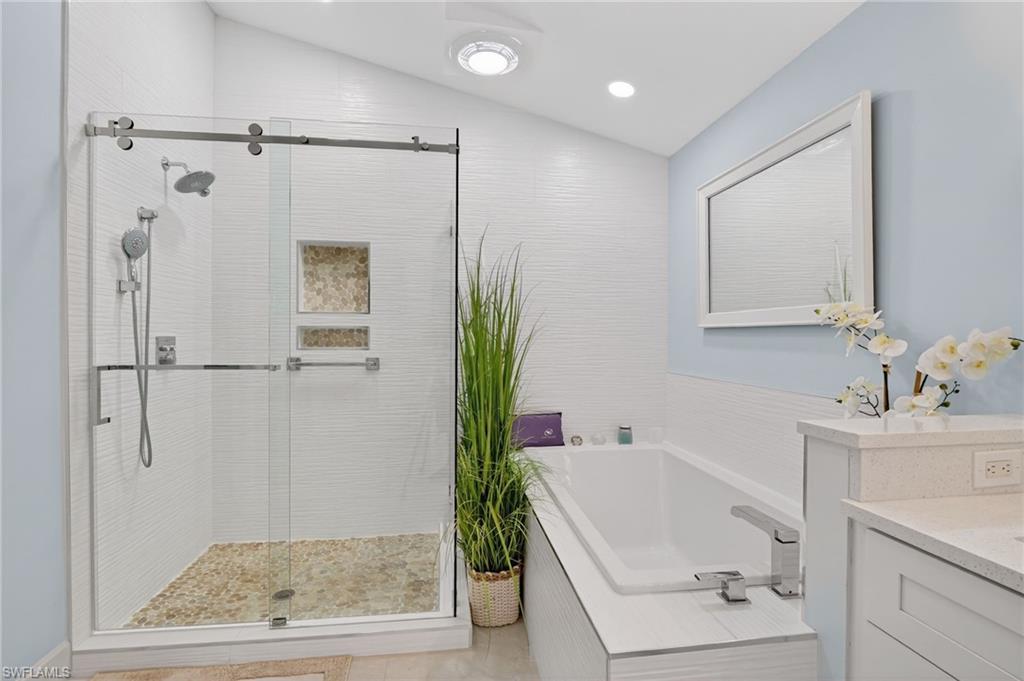 2248 Prince Lane Naples, FL 34112 - Photo 25 of 47 a bathroom with a tub a sink and mirror