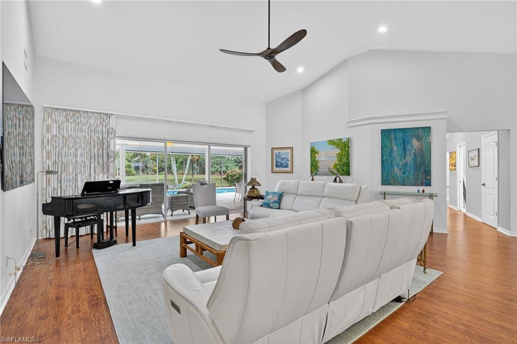 2248 Prince Lane Naples, FL 34112 - Photo 7 of 47 a living room with furniture a large window and wooden floor