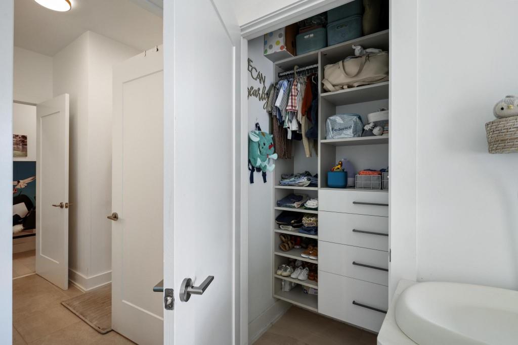 775 Juniper Street Northeast, Unit 602 Atlanta, GA 30308 - Photo 24 of 40 a view of walk in closet with clothes and shoes