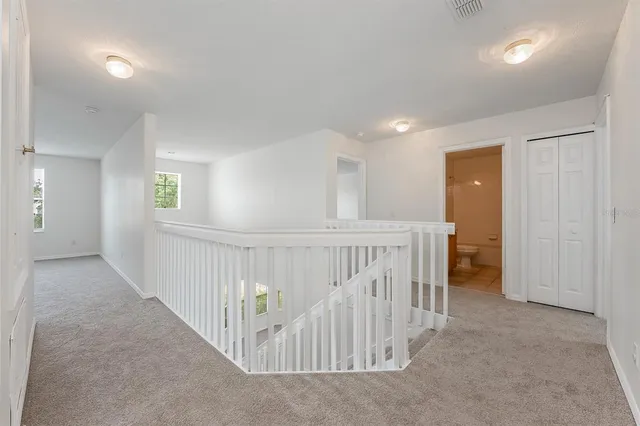 a living room with furniture and a potted plant on table