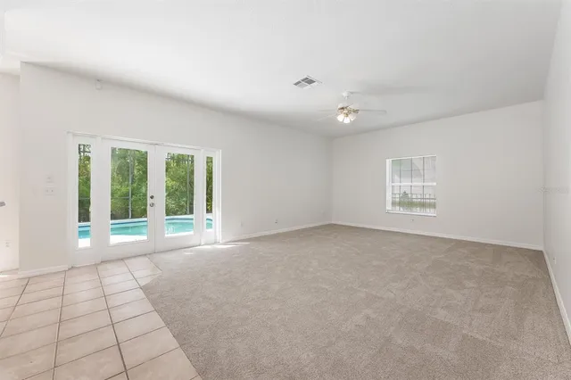 a view of a kitchen with a sink and chandelier fan
