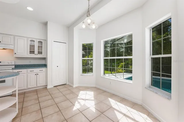an empty room with a window and a ceiling fan