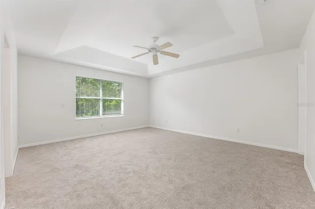 a view of an empty room with a ceiling fan