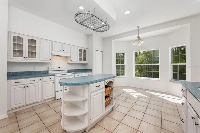 a kitchen with stainless steel appliances granite countertop a stove a sink and a granite counter tops