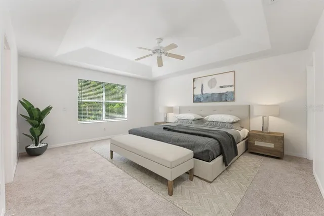 a spacious bedroom with a bed and a chandelier