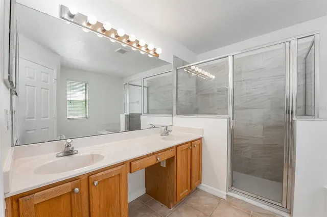 a bathroom with a sink double vanity and shower